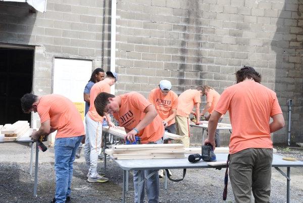 Utica students volunteer building beds for children at the non-profit Sleep in Heavenly Peace