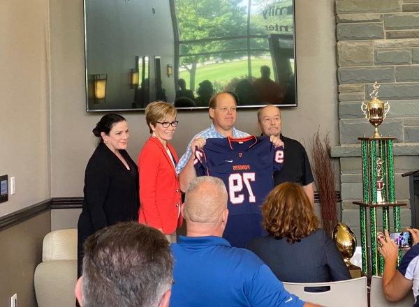 Floyd Fire Chief John Stark receives a jersey  as an honorary Pioneer Captain.