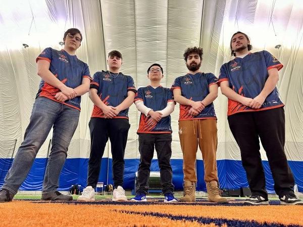 Members of the 2023 Esports Finals Team stands with arms resting in front.